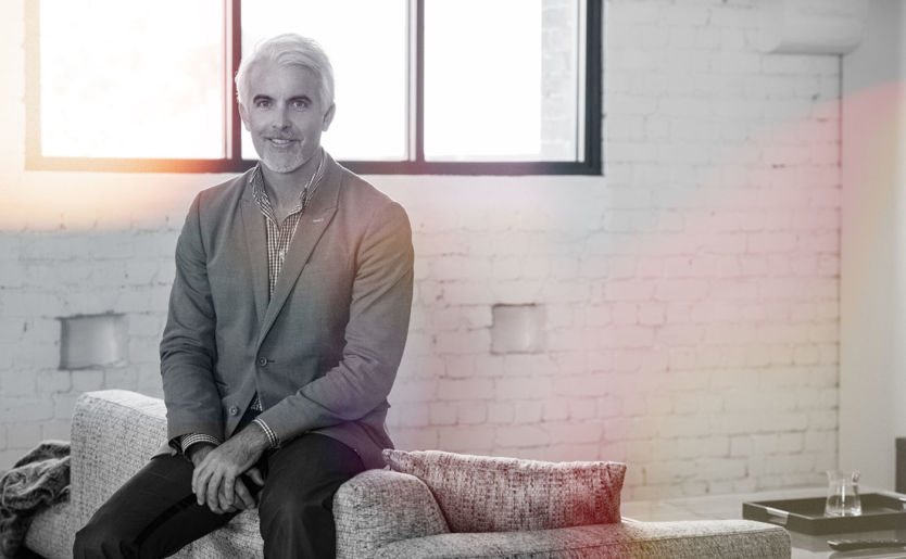 Managing Director of M/Group, Lloyd Clark, sitting on a couch