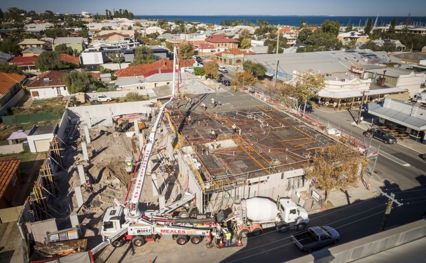 Aerial shot of construction works being done at M/28 Apartments by Match in South Fremantle showcasing a crane being used to carry materials onto the top level as well as concrete to the Level 2 slab