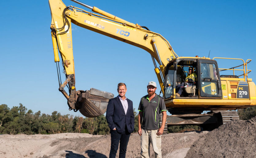 Johnno Wroth, Director of Monument parent company M/Group, stands with construction workers as stage one construction works are underway at The Wedge land development located in Wellard North